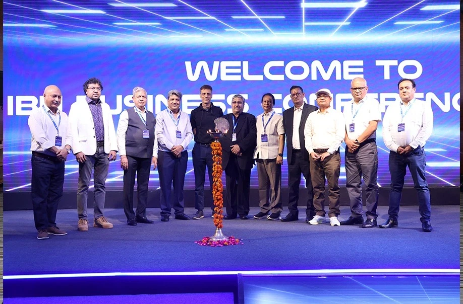 Group of professionals at business conference lamp lighting ceremony.