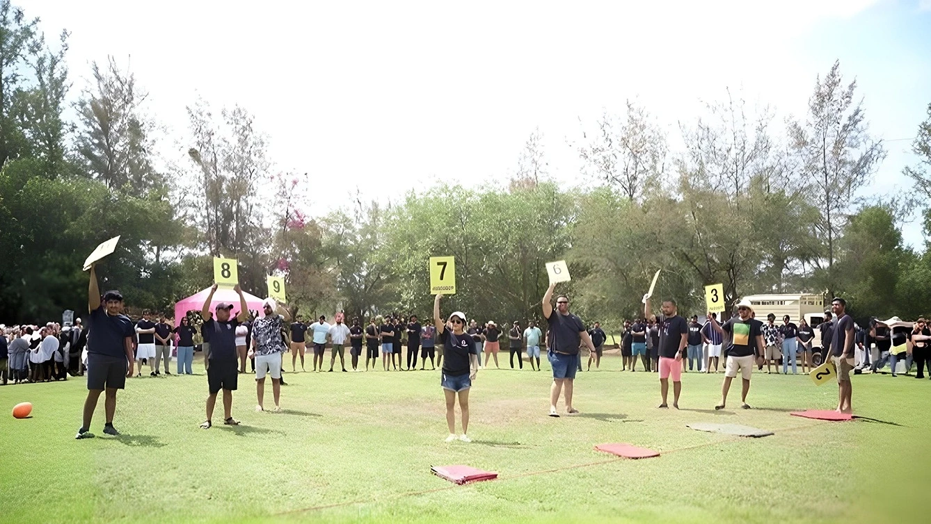 People outdoors holding numbered signs during a group event.