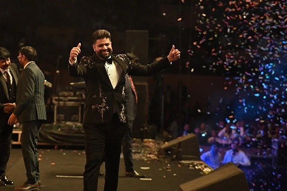 Man celebrating on stage during grand product launch event