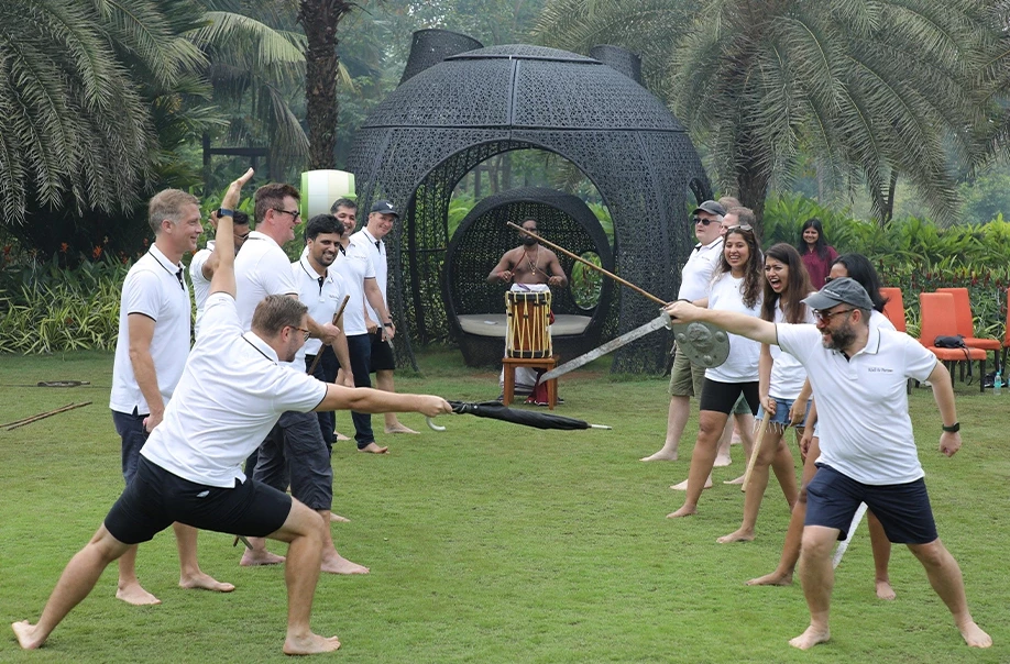 Team enjoying fun sword play activity outdoors